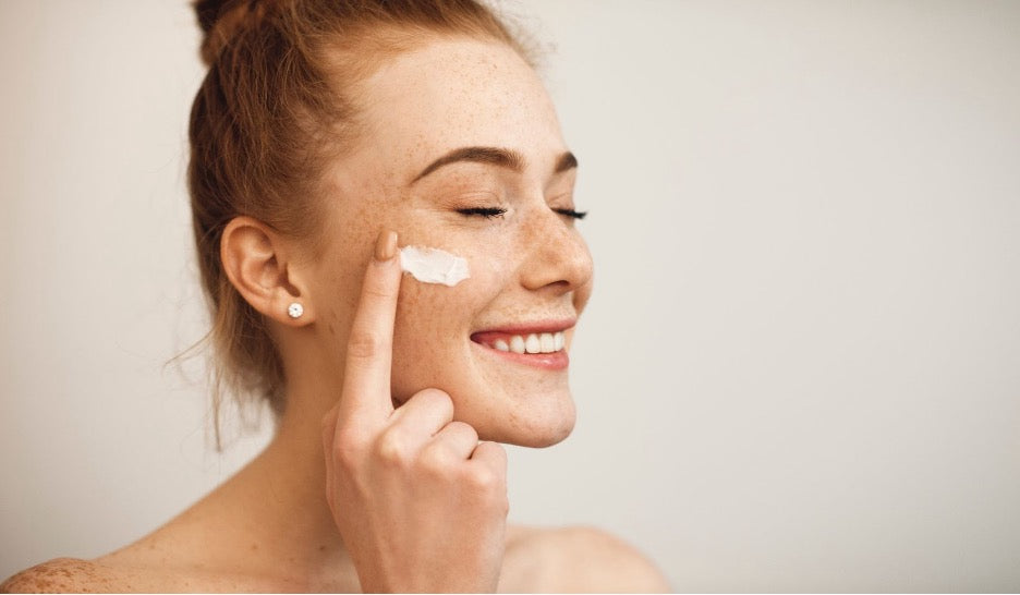 A person applying their skincare products.