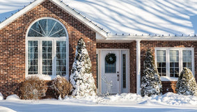 A home in winter covered in snow.