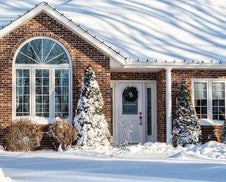 A home in winter covered in snow.