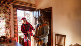 A family arriving home in the winter.