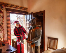 A family arriving home in the winter.