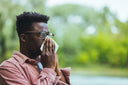 An image of the ten worst states for allergies shown by a man sneezing.