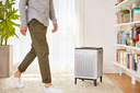 Man Walking By Coway Airmega 300 Air Purifier In Living Room