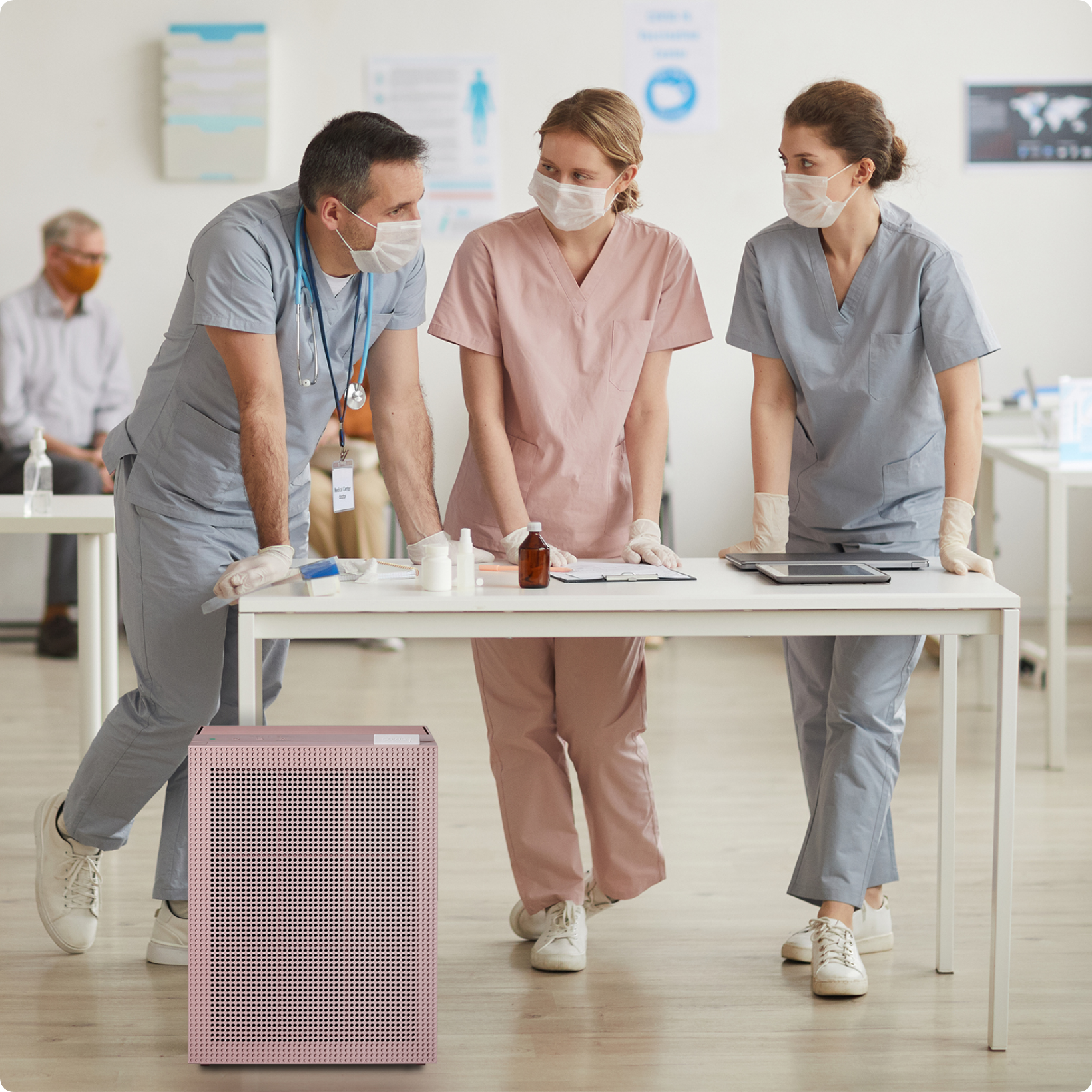 Nurses standing at a table with Airmega air purifier
