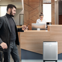 Man walking near front desk with Airmega air purifier