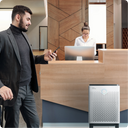 Man walking near front desk with Airmega air purifier