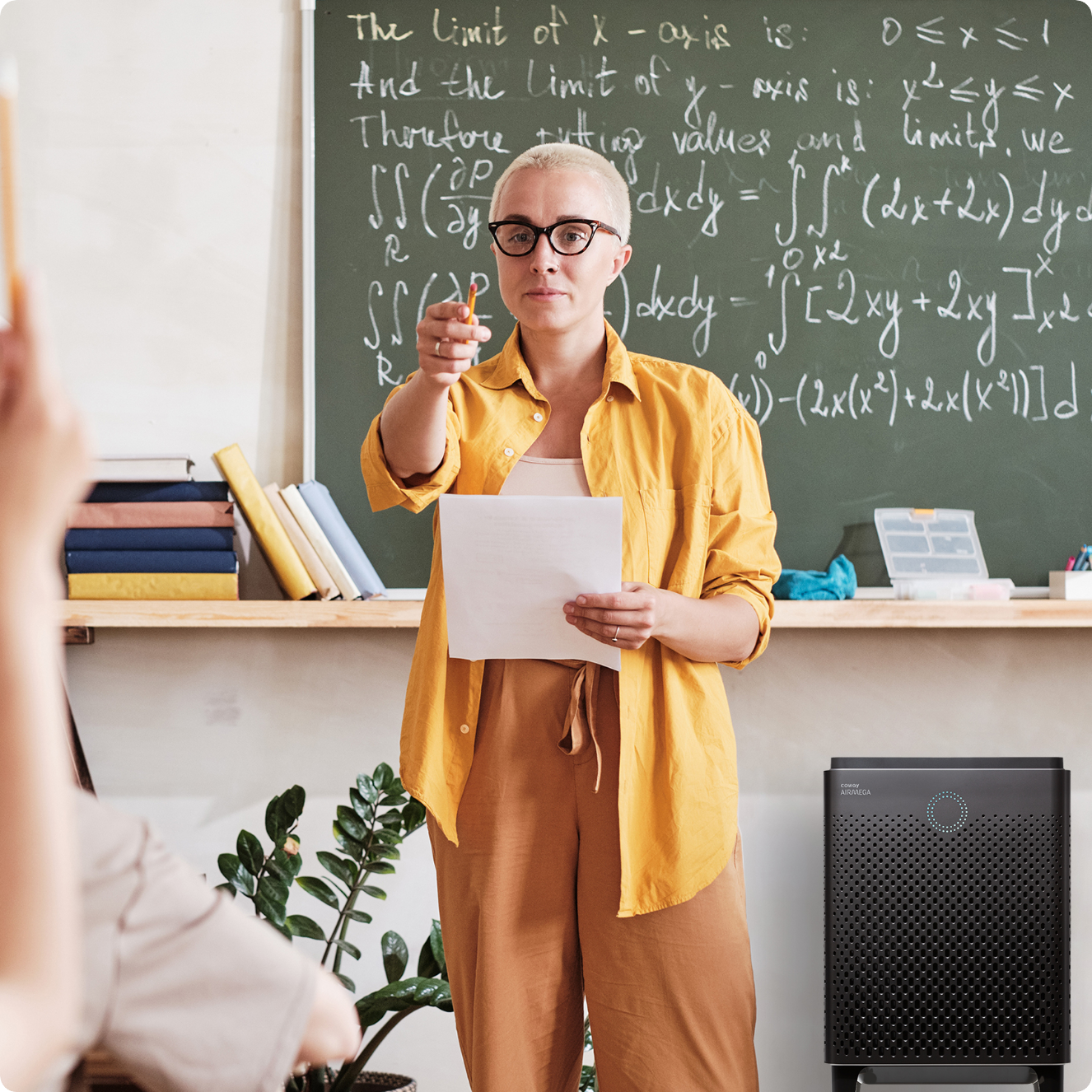 Teacher pointing at students in classroom with Airmega air purifier