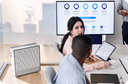 Office workers at a desk with Airmega air purifier in the background